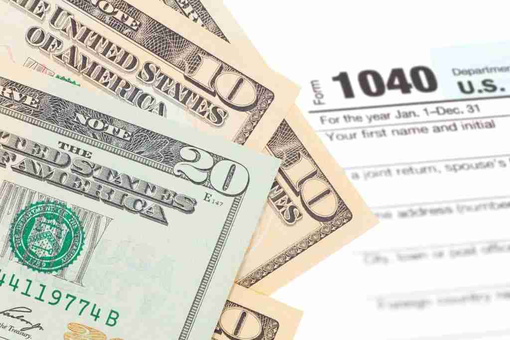 Money laid over the top of a tax refund form